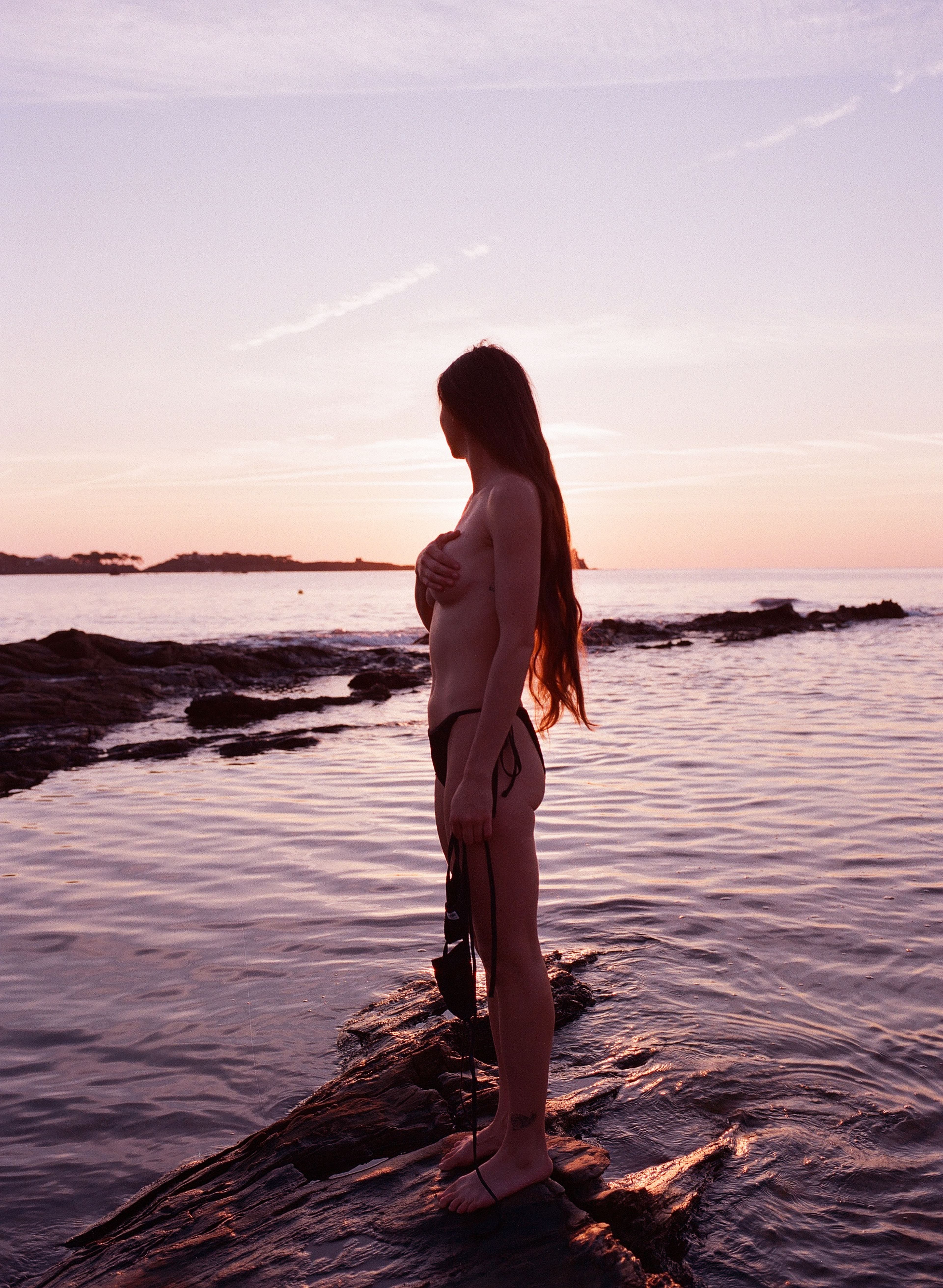 Kimbra by the ocean at sunset