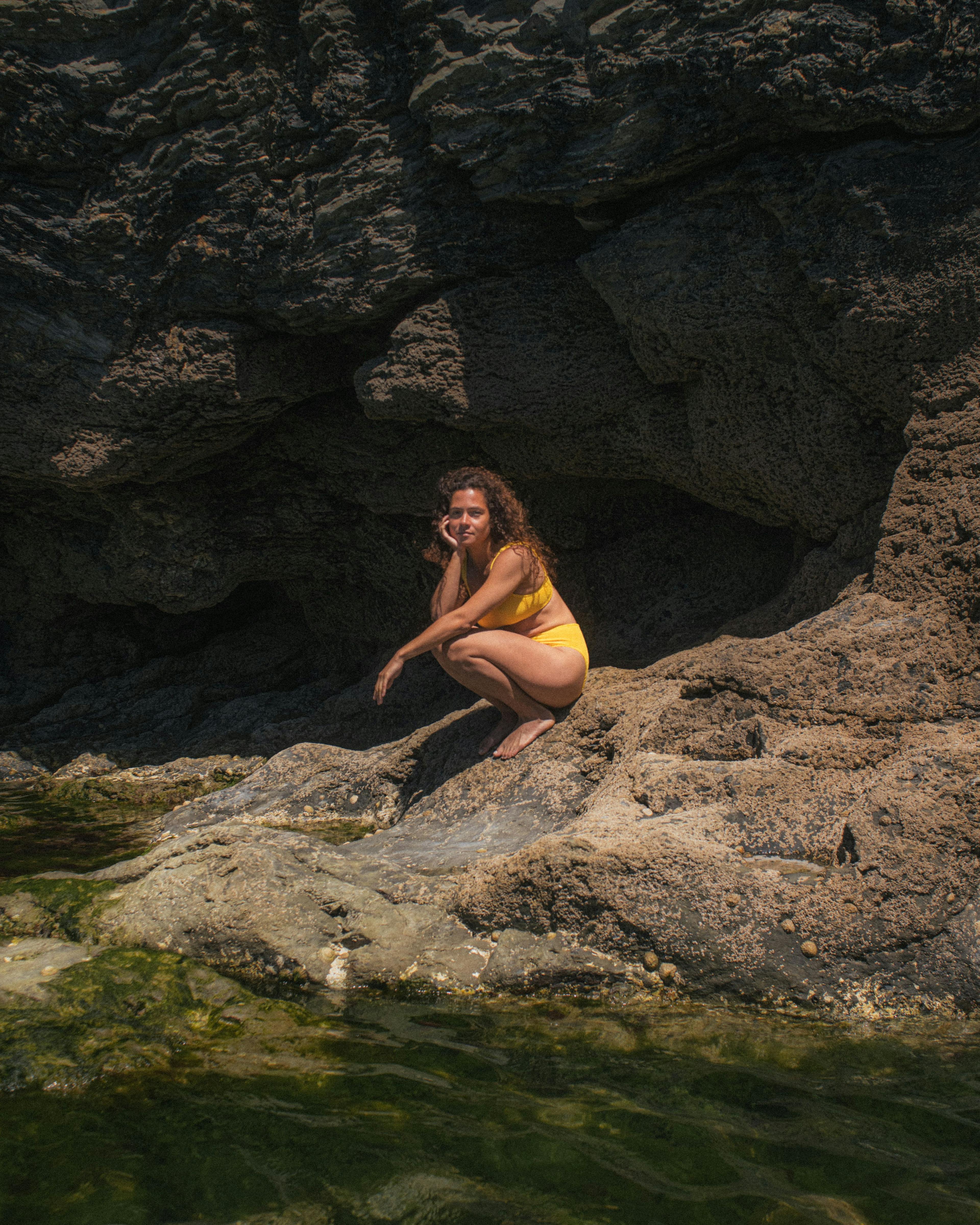Lily sitting on rocks