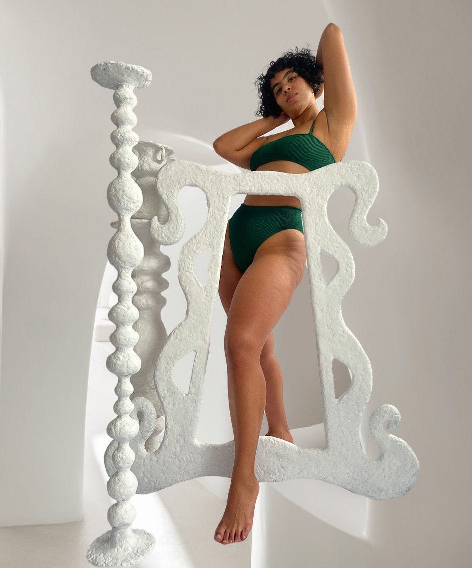 Nadine in green bikini with sculptures